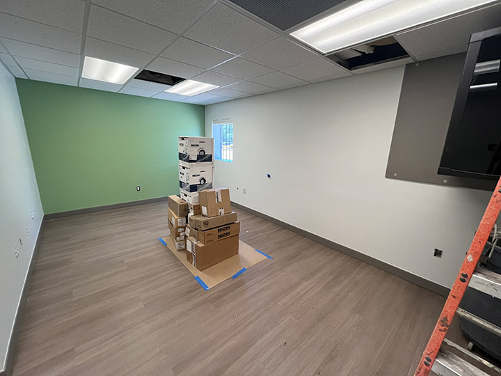 Empty room with wood floor and stack of boxes
