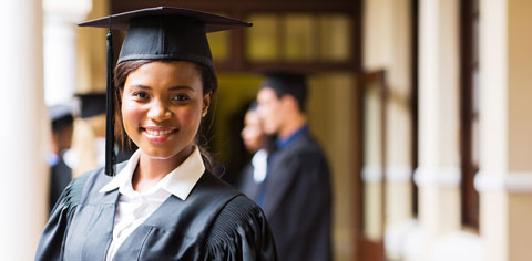 Young woman in graduation cap and gown